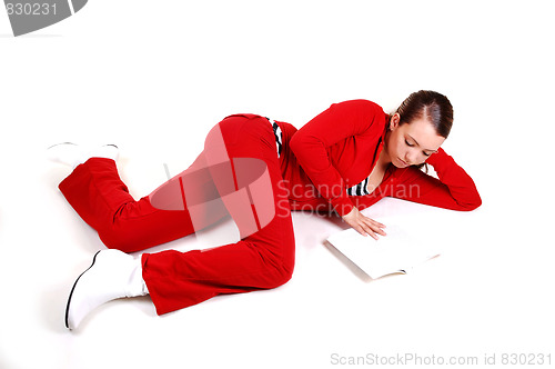Image of Girl lying on floor and reading. 