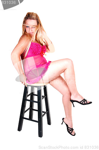 Image of Blond woman in pink lingerie.