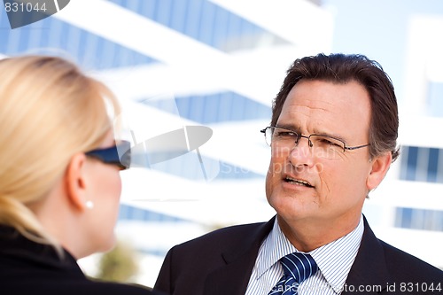 Image of Businessman Talking with Female Colleague