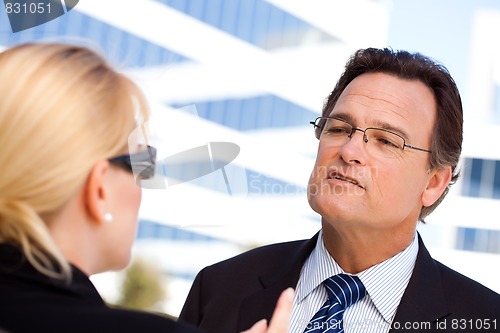 Image of Businessman Talking with Female Colleague