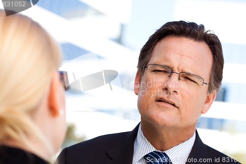 Image of Businessman Talking with Female Colleague