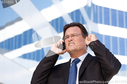 Image of Excited Businessman on Cell Phone