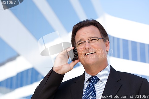 Image of Businessman Smiles as He Talks on His Cell Phone