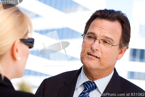 Image of Businessman Talking with Female Colleague