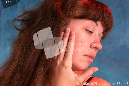 Image of beautiful woman touching face