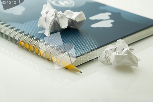 Image of crumpled papers and notebook