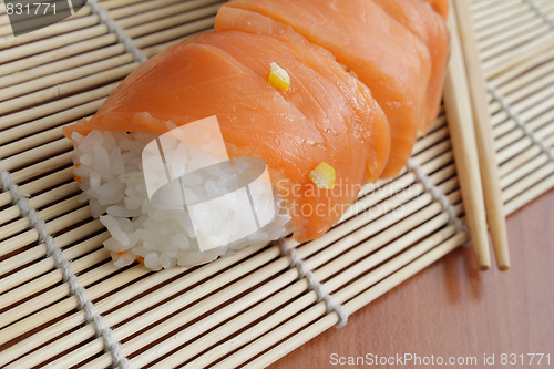 Image of Salmon sushi on bamboo mat