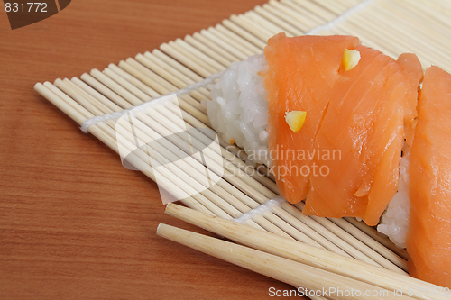 Image of Salmon sushi on bamboo mat