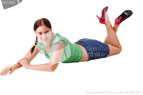 Image of Pretty girl in shorts lying on the floor.
