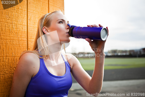 Image of Sporty woman drinking