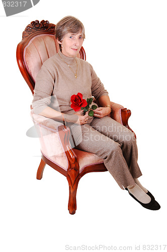 Image of Lady sitting on chair.