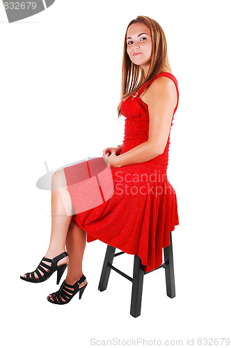 Image of Woman sitting on chair.