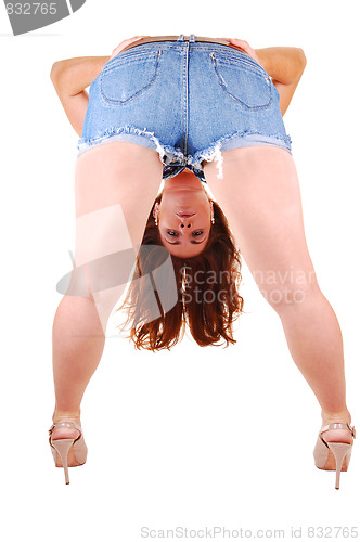 Image of Pretty girl in jeans mini skirt.