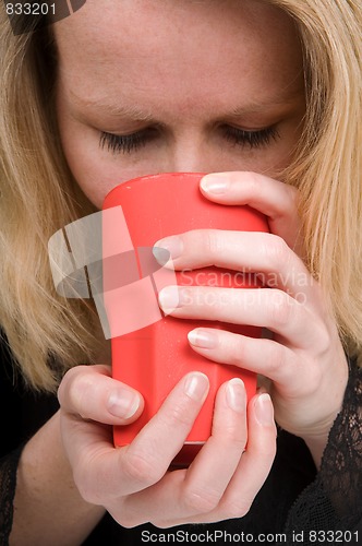Image of Woman holding a cup of coffee
