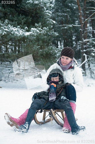 Image of Boy and girl on a sled