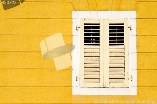 Image of Yellow wall an and wooden window