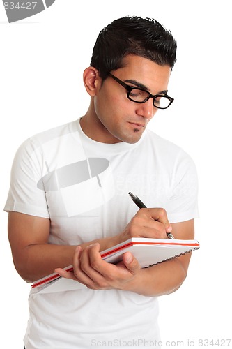 Image of Student or man wearing glasses writing