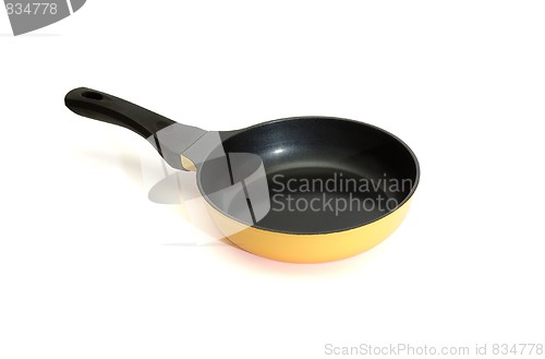 Image of Black and yellow frying pan isolated