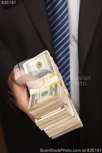 Image of Businessman Handing Over Stack of Cash