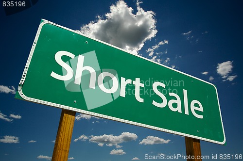 Image of Short Sale Green Road Sign Over Clouds