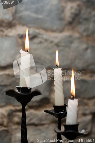 Image of Three candles in candlestick