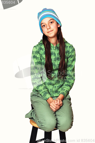 Image of Teenager kneeling on chair.