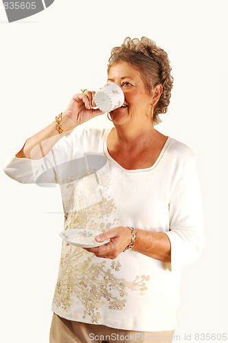 Image of Senior woman tingling coffee.