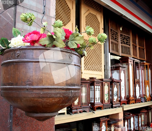 Image of Flower pot hanging with oriental lights in the background