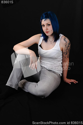 Image of Blue hair girl sitting.