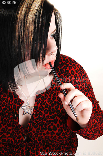 Image of Young girl doing makeup.