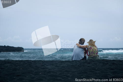 Image of Couple sitting on the sand