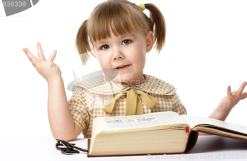 Image of Happy little girl with book, back to school