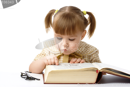 Image of Cute little girl reading books, back to school