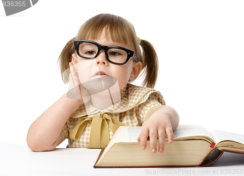 Image of Happy little girl with book, back to school