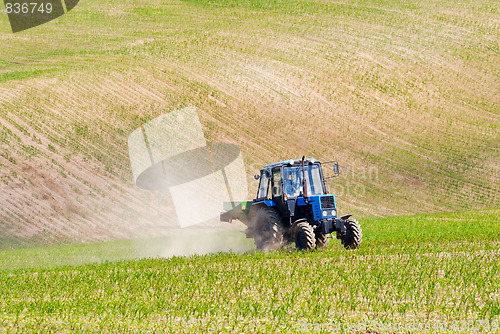 Image of Tractor in a field in early summer