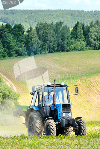 Image of Tractor in a field in early summer