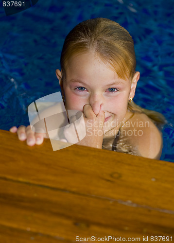 Image of cute preteen in a swimming pool