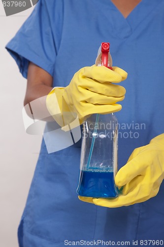 Image of Asian woman nurse holding cleaning solution