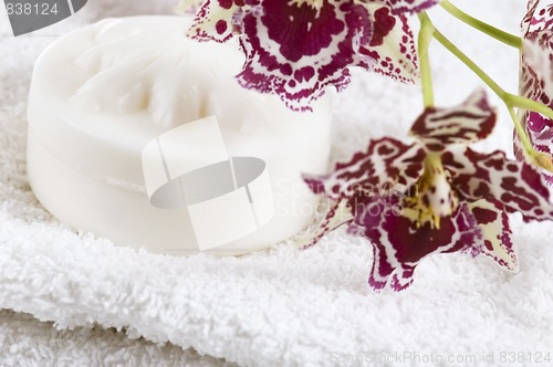 Image of Spa items with white towels, natural soap and orchid