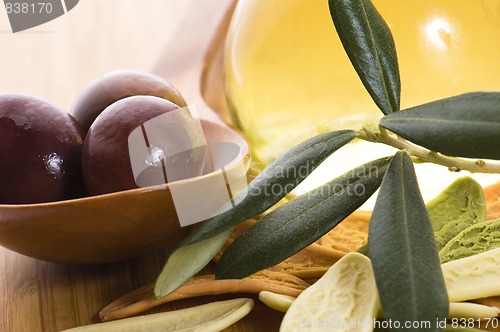 Image of pasta, black olives, oil with fresh branch. food ingredients 