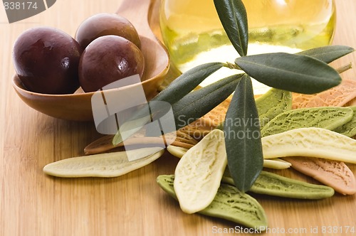 Image of pasta, black olives, oil with fresh branch. food ingredients 