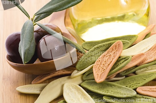 Image of pasta, black olives, oil with fresh branch. food ingredients 