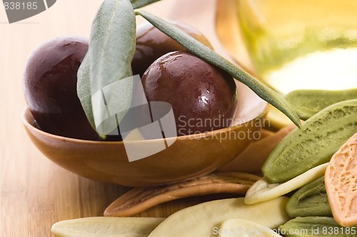 Image of pasta, black olives, oil with fresh branch. food ingredients 