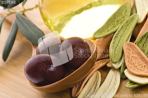 Image of pasta, black olives, oil with fresh branch. food ingredients 