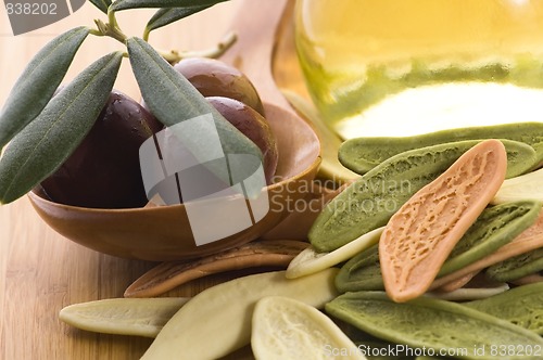 Image of pasta, black olives, oil with fresh branch. food ingredients 