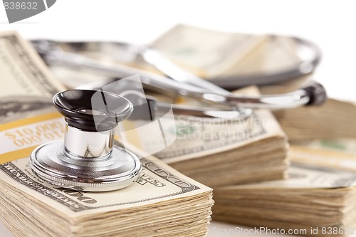 Image of Stethoscope Laying on Stacks of Money