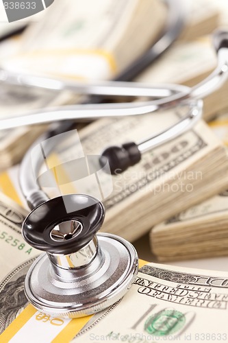 Image of Stethoscope Laying on Stacks of Money