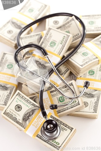 Image of Question Mark Shaped Stethoscope Laying on Money
