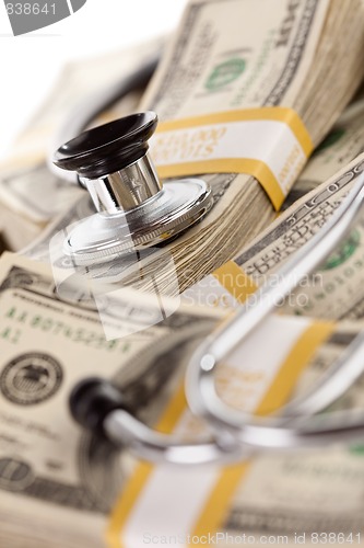 Image of Stethoscope Laying on Stacks of Money