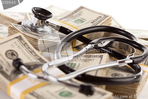 Image of Stethoscope Laying on Stacks of Money